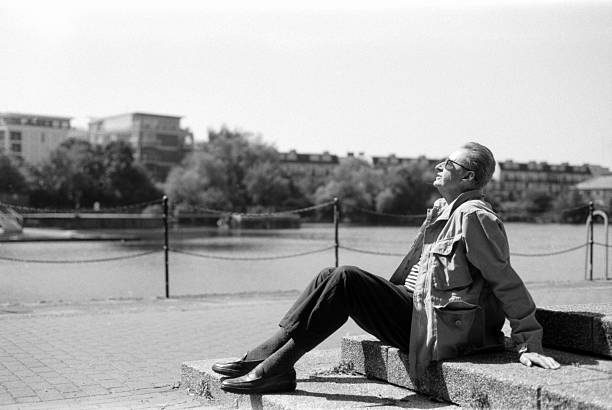 istock Senior man relaxing by the river in black and white 2245924886