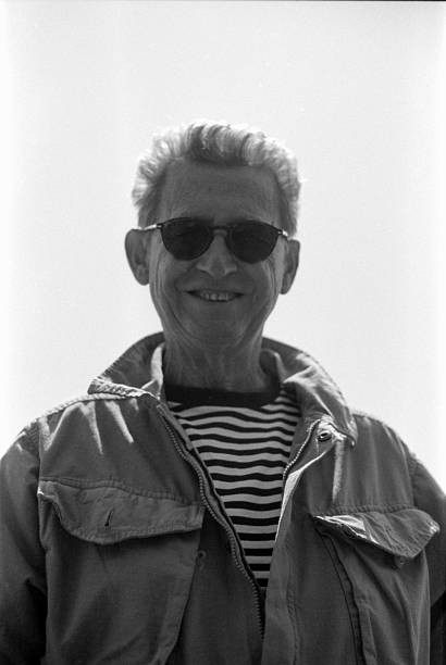 istock Senior man smiling wearing sunglasses and jacket in monochrome 2245924892