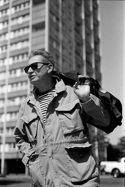 istock Senior man walking in the city with bag on shoulder 2245924896