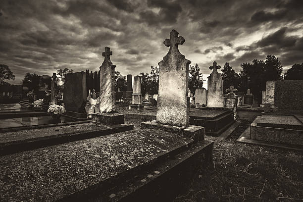 istock Spooky dark cemetery on a cloudy autumn day 2245925993