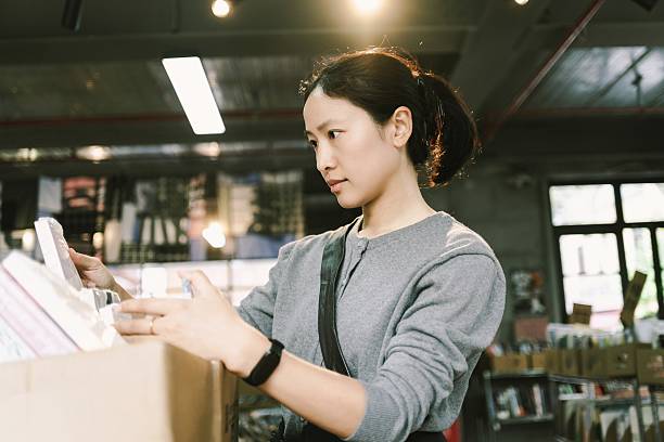 istock An Asian woman is in a second-hand bookstore, choosing second-hand books, second-hand stores, recycling stores, and eco-friendly stores 2245926830