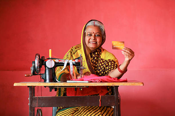 Indian rural woman using sewing machine at home