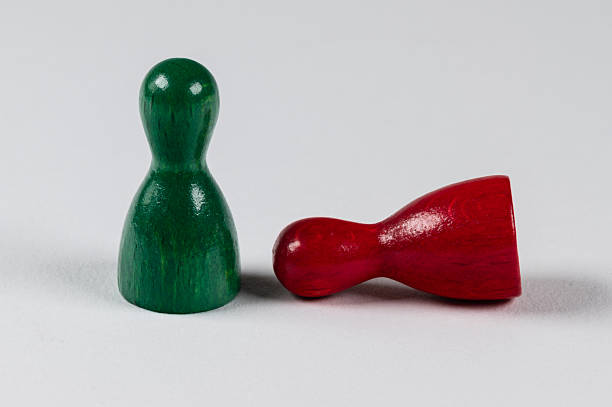 istock Two wooden game pieces 2245937435