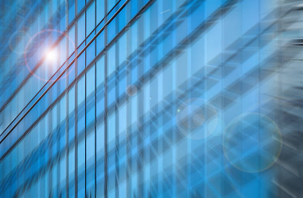 istock A dynamically blurred, urban architectural facade with radial blur. Bright light streaks across modern blue glass panels. 2245938198