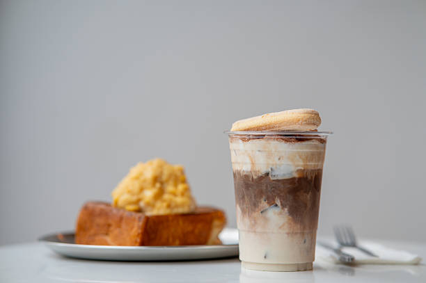Toast with corn ice cream as topping on table with a cup of drink