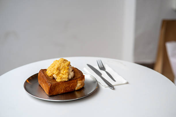 Toast with corn flavored ice cream as topping beside cutlery