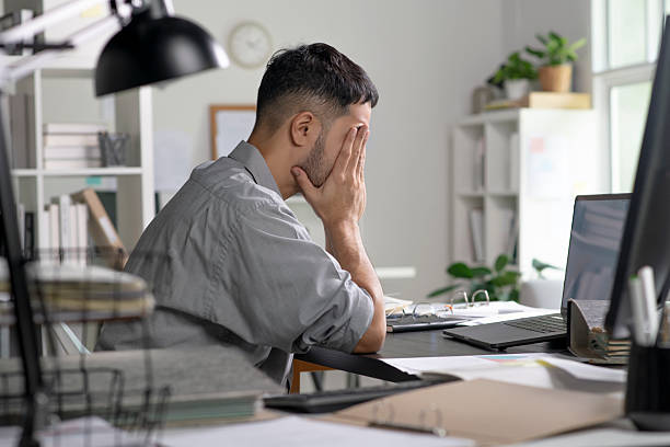 istock Businessman looking stressed from work, Businessman working at office feels overworked and burnout 2245939364