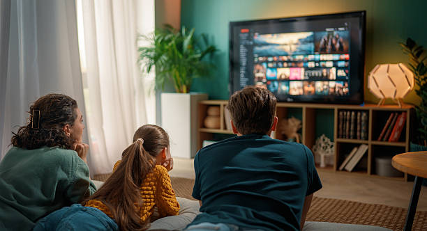 istock family watching  TV at home 2245941203