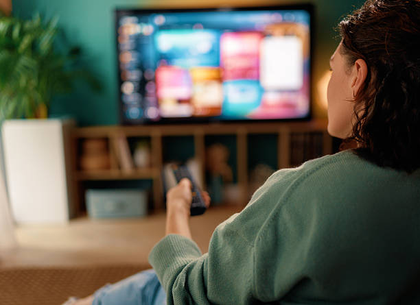 istock woman watching TV 2245941209