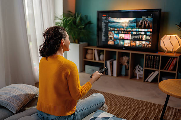istock woman watching TV at home 2245941218