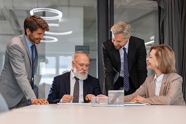 istock Successful businesspeople working in a coworking space working with laptop discussing strategy and business plan in modern office. 2245943284