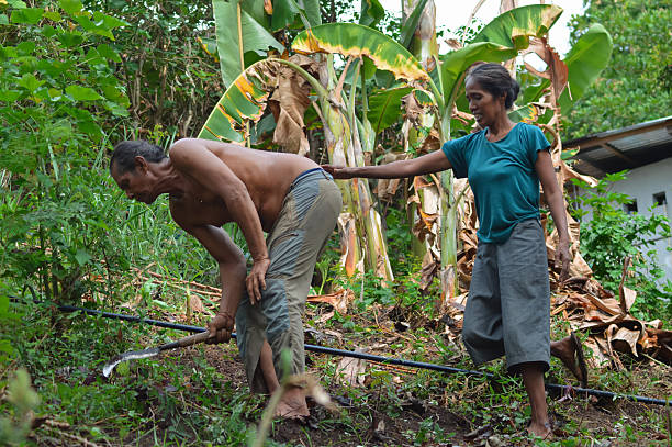 istock Wife Supporting Bending Shirtless Farmer Husband Working on Sloping Field 2245944453