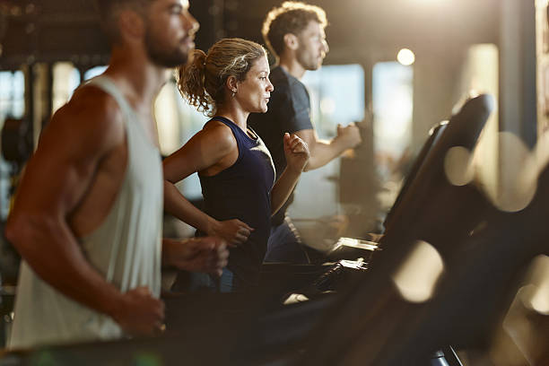 istock Athletic people running on treadmills in a gym. 2245944457