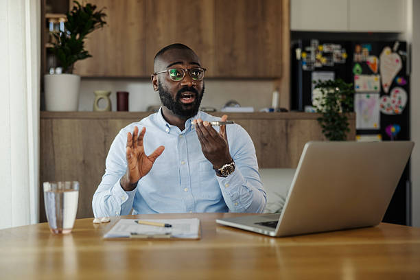 istock Black man recording voice message on phone 2245944724