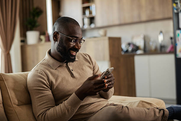istock African american man relaxing, using phone at home 2245944805