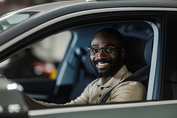 istock African american man smiling while driving car 2245944893