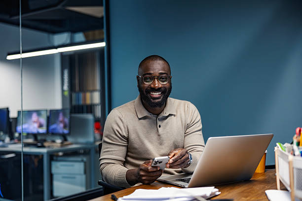istock African american businessman smiling and using phone in office 2245944938