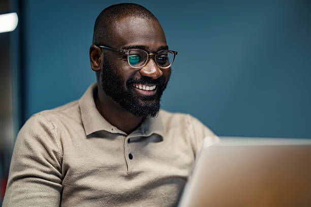 istock African american man smiling while working on laptop 2245944979