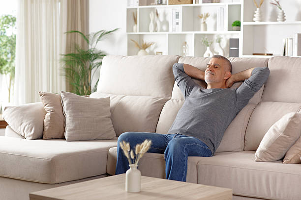 istock Relaxed senior man resting sitting on a couch at home 2245944980