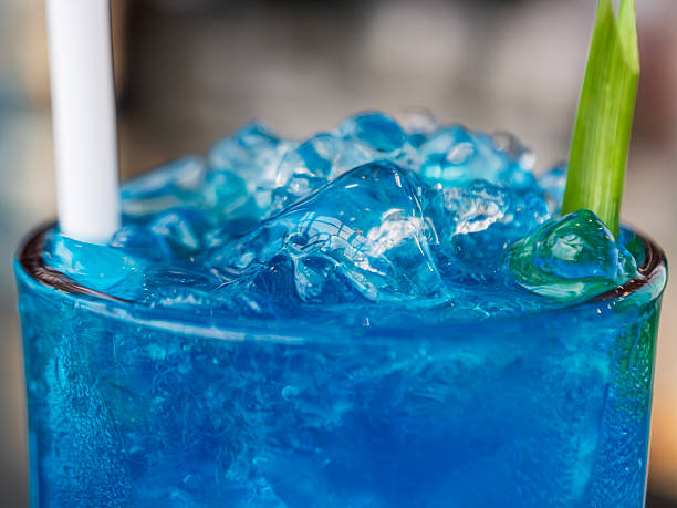 istock A vibrant blue drink filled with ice in a transparent glass. 2245945103