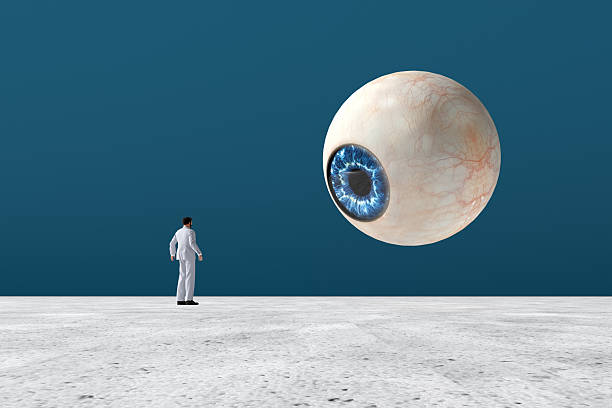 istock Businessman looking at a giant eye floating in the sky 2245945208