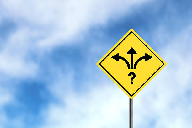 Road sign with a question mark and three diverging arrows symbolizing difficult decision making