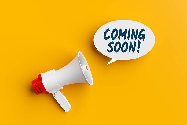 istock Megaphone Announcing Coming Soon on Yellow Background 2245945266