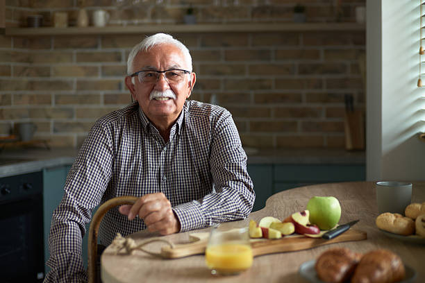 istock Happy mature man enjoying at dining table. 2245945378