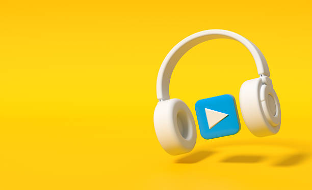 istock White headphones playing music on yellow background 2245945432