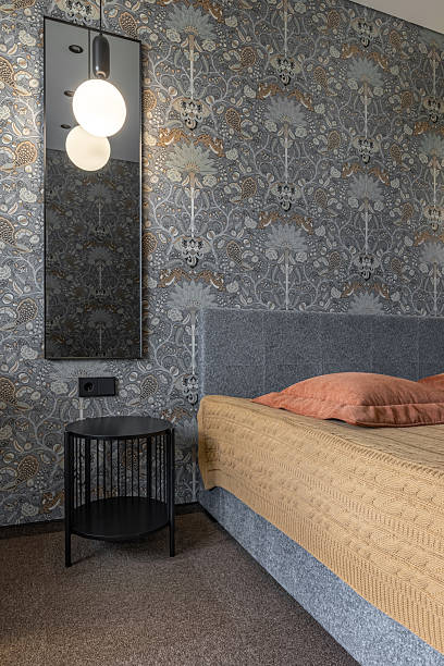 istock Cozy Bedroom Corner with Bedside Table and Decorative Wallpaper 2245946915