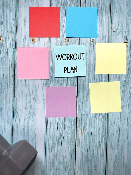 istock Workout Plan with Empty Colorful Paper and Dumbbell 2245949047