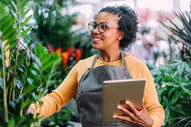 istock Female florist using digital tablet in flower shop. 2245952197