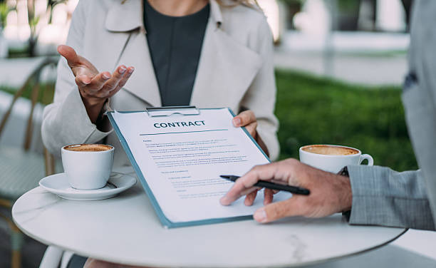istock Business people signing a contract in sidewalk cafe. 2245953294