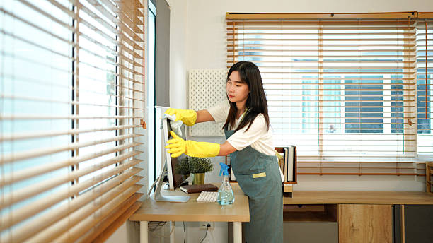istock Female worker of cleaning service wiping computer screen in office 2245953331