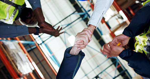 istock Business people, handshake or logistics with applause for partnership or distribution in storage. Low angle, employees or colleagues shaking hands with deal for shipping or supply chain in depot 2245954052