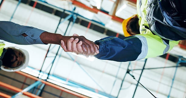 istock Business people, handshake or logistics with team below for partnership or distribution in storage. Employees, colleagues or distributor shaking hands with deal for shipping or supply chain in depot 2245954063