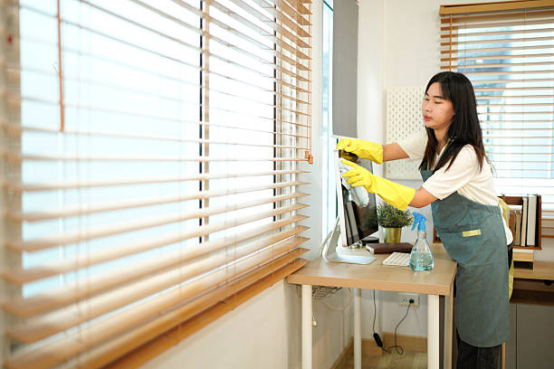 istock Female worker of cleaning service wiping computer screen in office 2245954250