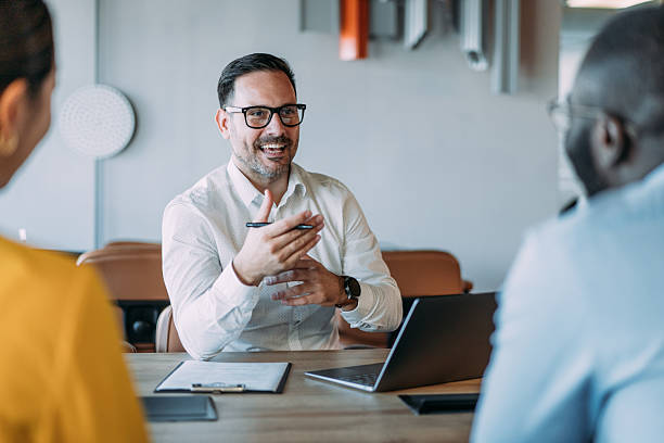 istock Group of business persons talking in the office. 2245956477
