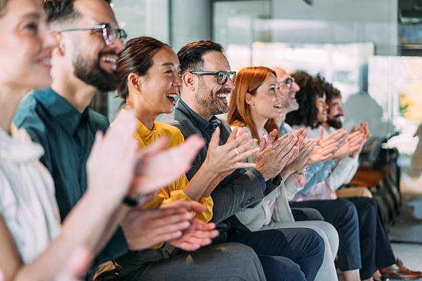 istock Businesspeople applauding during a seminar in conference hall. 2245956529