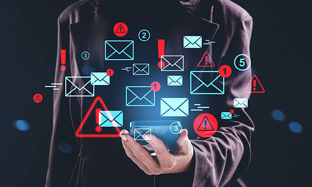 istock Digital email warning hologram concept with notifications and alerts displayed above a phone held by a person in a dark background environment. 2245958874