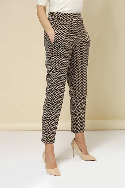 istock Studio photography of young female model wearing comfortable cigarette brown patterned cropped trousers and nude high heels 2245958882