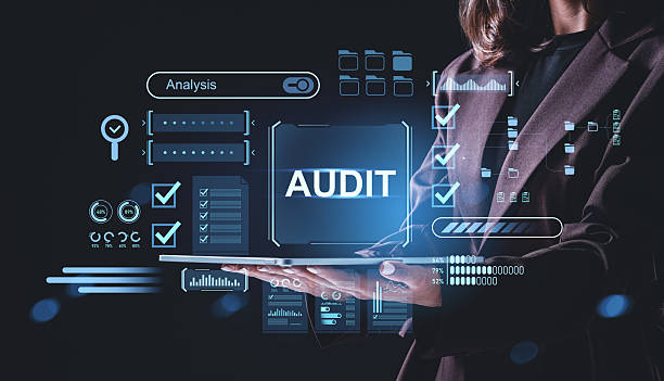 istock Businesswoman holding tablet with holographic audit interface and data analysis elements for financial control concept on dark background.. 2245959326