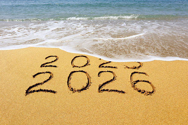 istock New year 2026 and 2025 on sandy beach with waves 2245960530