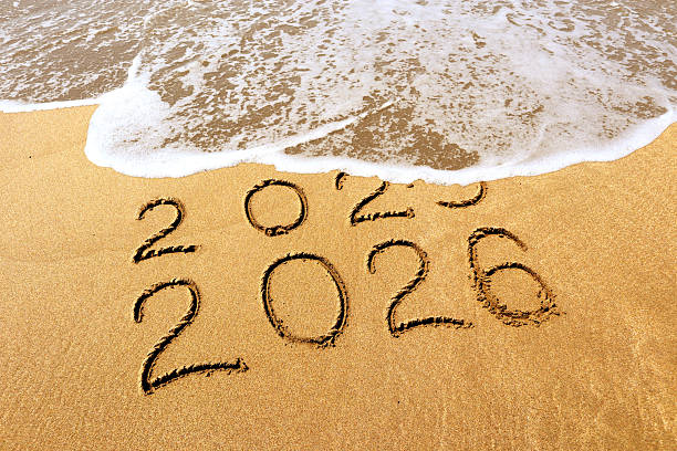 istock New year 2026 and 2025 on sandy beach with waves 2245960663