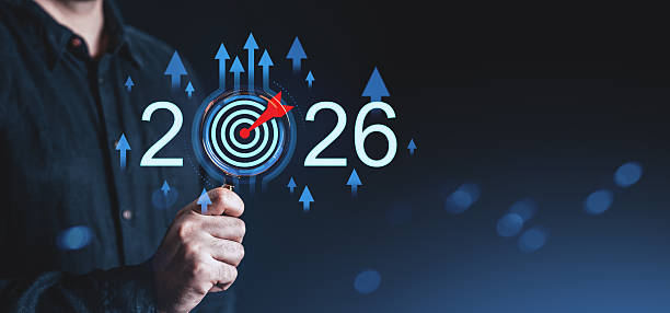 istock Businessman pointing at target with dart inside number 2026, symbolizing future goals and strategic planning for startup success and growth concept. 2245960750