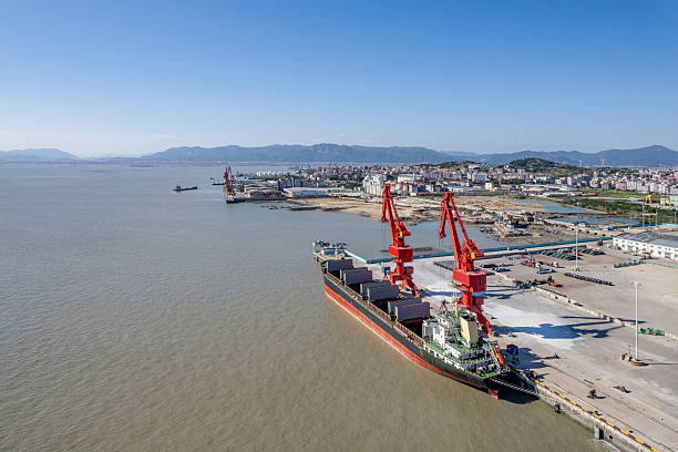 istock Cranes at the cargo port are loading materials onto a cargo ship. 2245961206