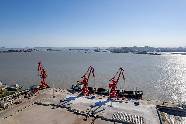 istock Cranes at the cargo port are loading materials onto a cargo ship. 2245961210