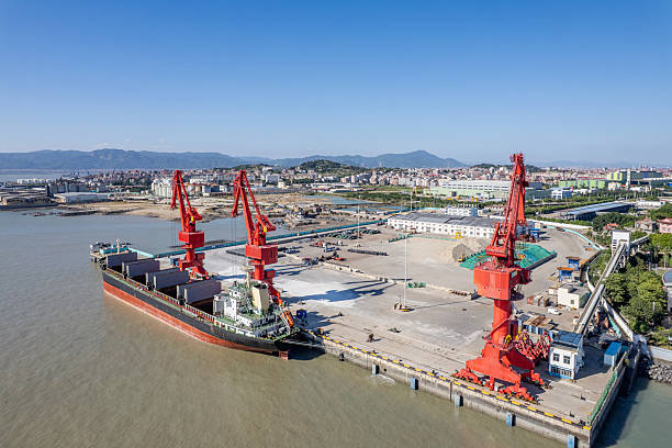 istock Cranes at the cargo port are loading materials onto a cargo ship. 2245961257