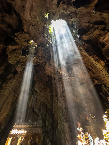 istock Dramatic sunbeams pierce through openings in Phraya Nakhon Cave, Thailand, illuminating the majestic Phra Thinang Khuha Kharuehat Pavilion and ancient rock formations. A mystical, awe-inspiring 2245962748