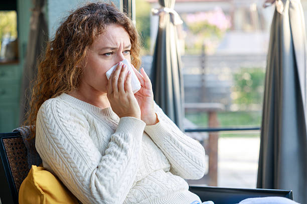 istock Young woman suffering from cold 2245969726